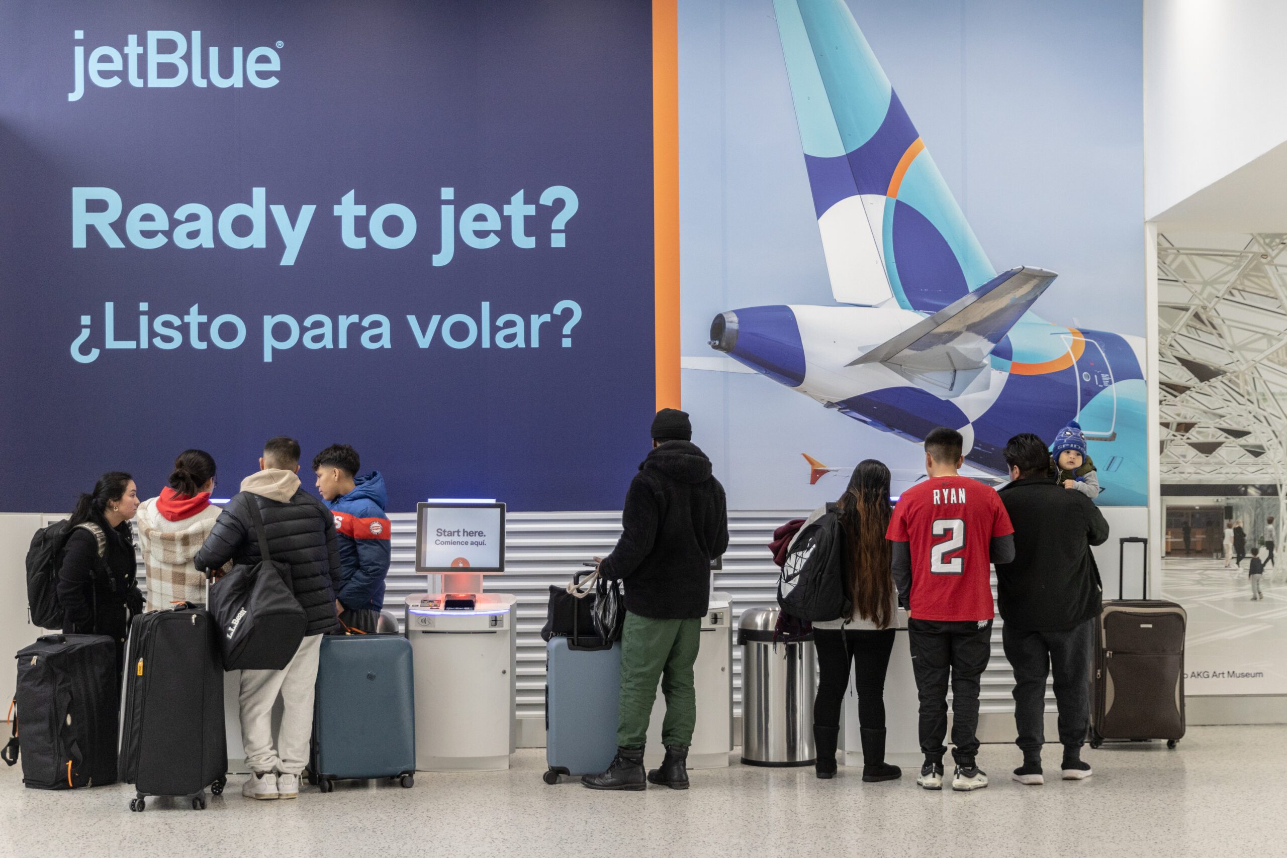 Travelers check-in for their flights for JetBlue flights at John F. Kennedy International Airport (JFK) on December 23, 2023 in New York, New York.