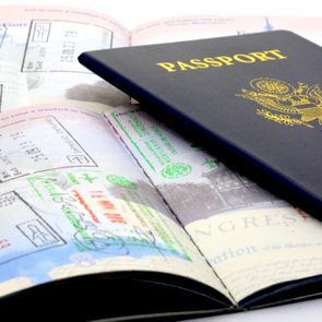 A passport sits on top of pages of passport stamps