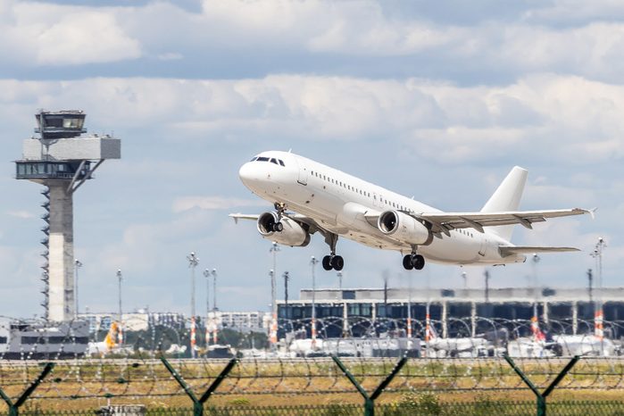 Starting white passenger aircraft at airport Berlin-Brandenburg BER