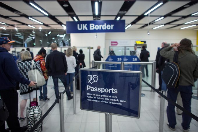 People line up for passport control at London's Gatwick Airport