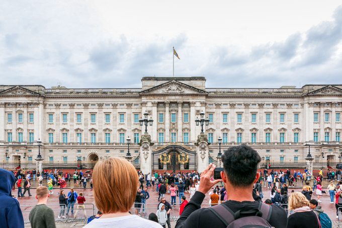 Tourist Taking Picture Of The Majestic And Iconic Buckingham Palace In London