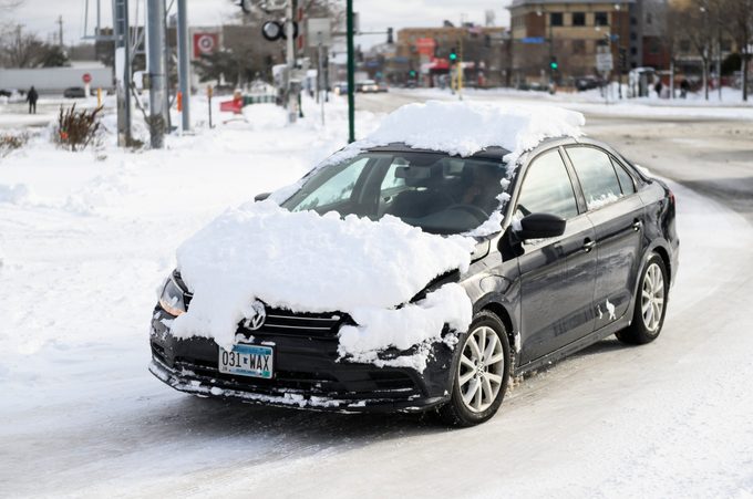 Black car covered with snow