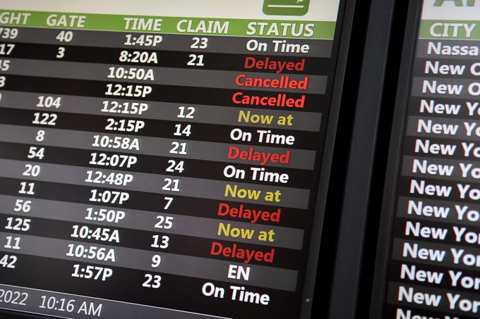 Flight departure board at an airport showing mostly cancelled or delayed flights