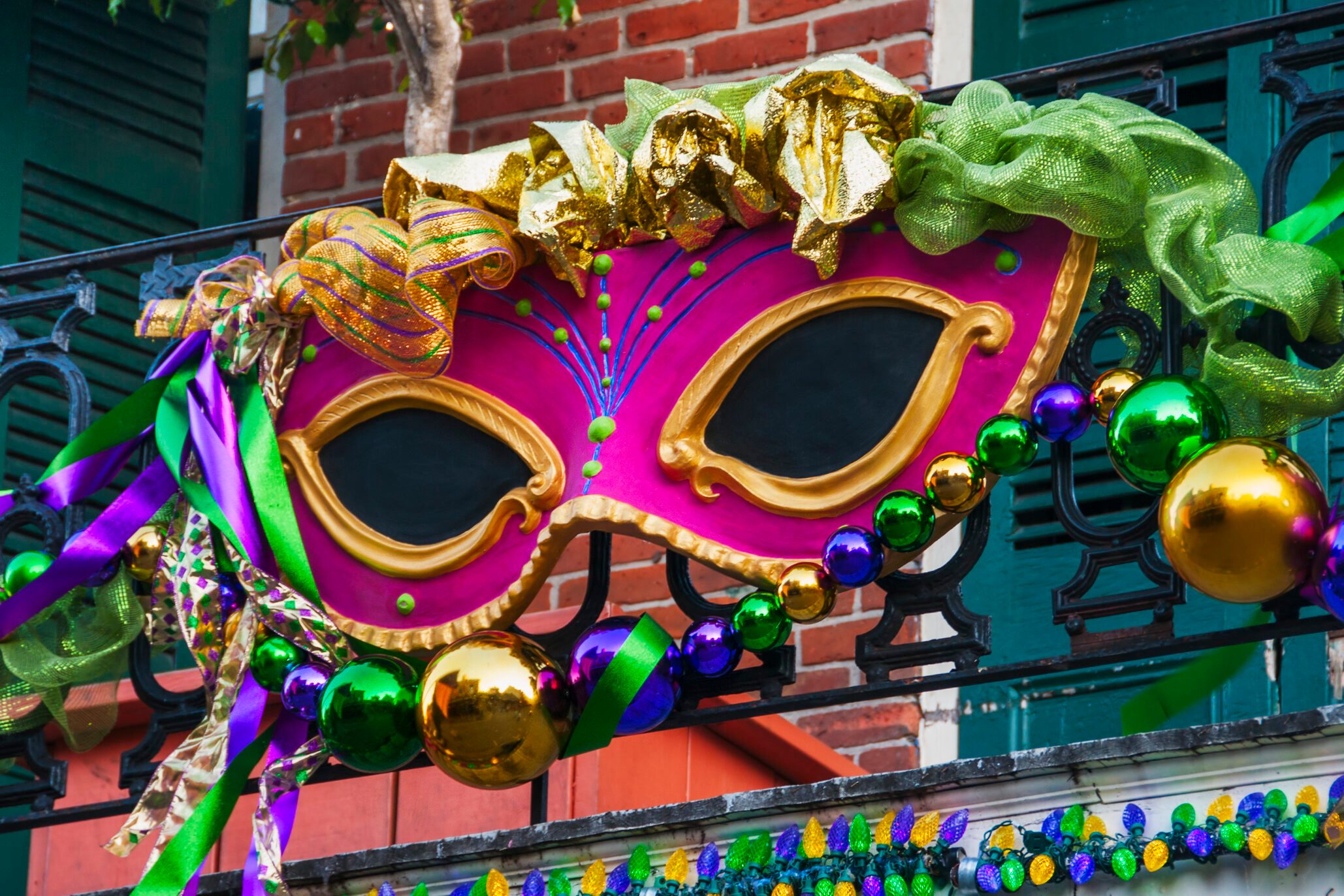 USA, New Orleans, Louisiana, Mardi Gras mask hanging on balcony's railing