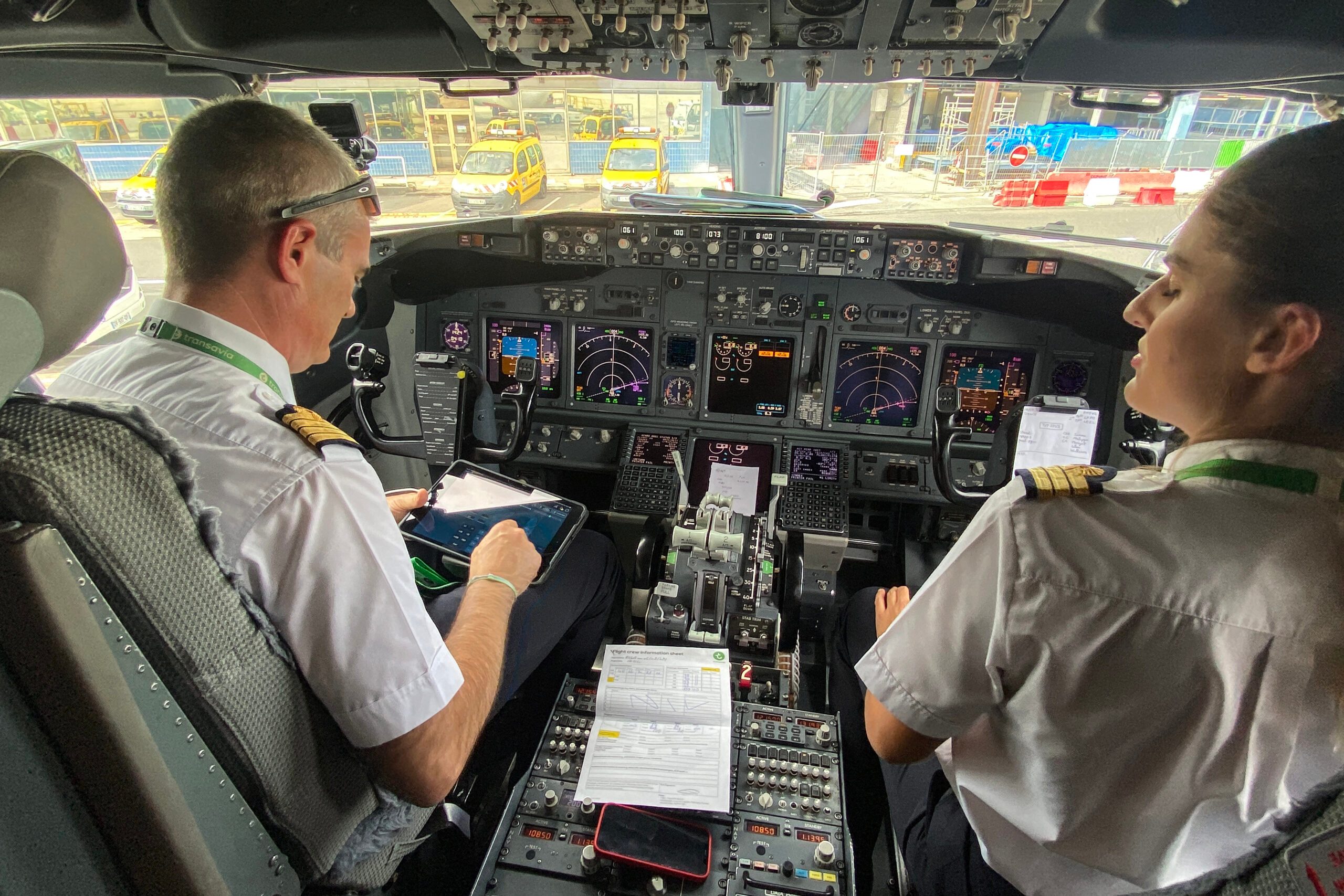 Two pilots in the cockpit of a commercial airliner
