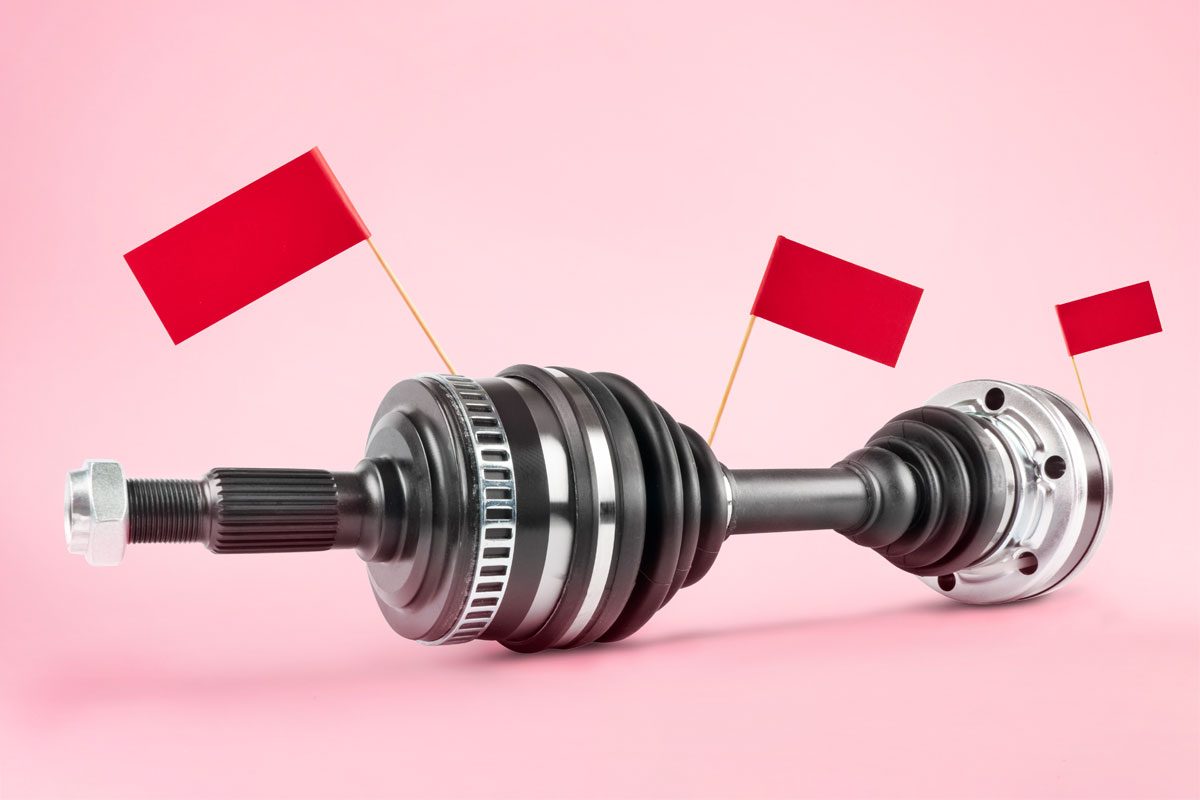 car axle with red flags against a pink background