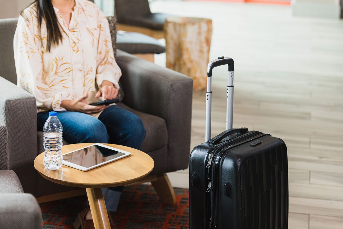 woman waiting in lobby to get a room