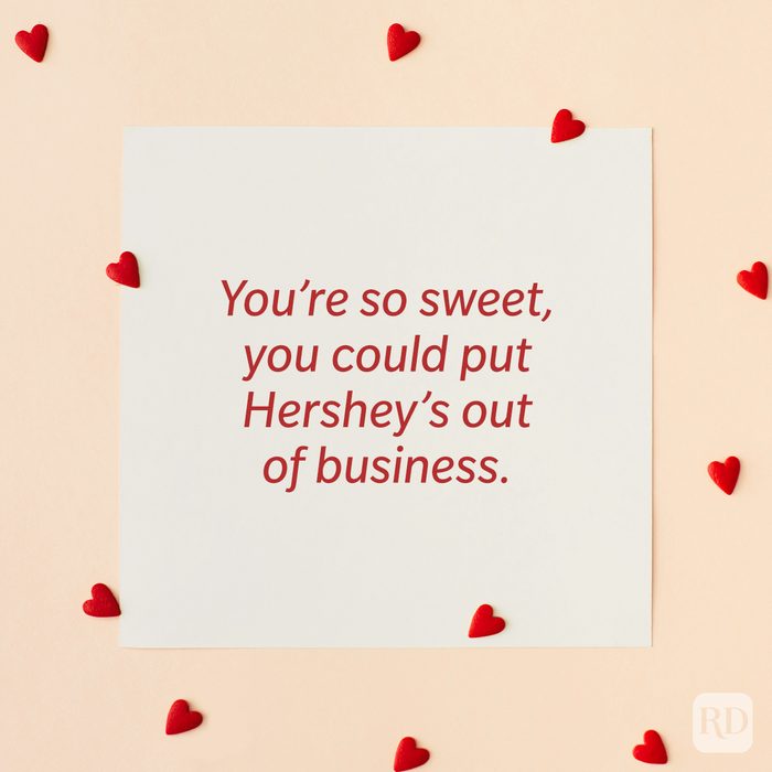 Valentine’s Day Pickup Line on paper background with scattered hearts around it background