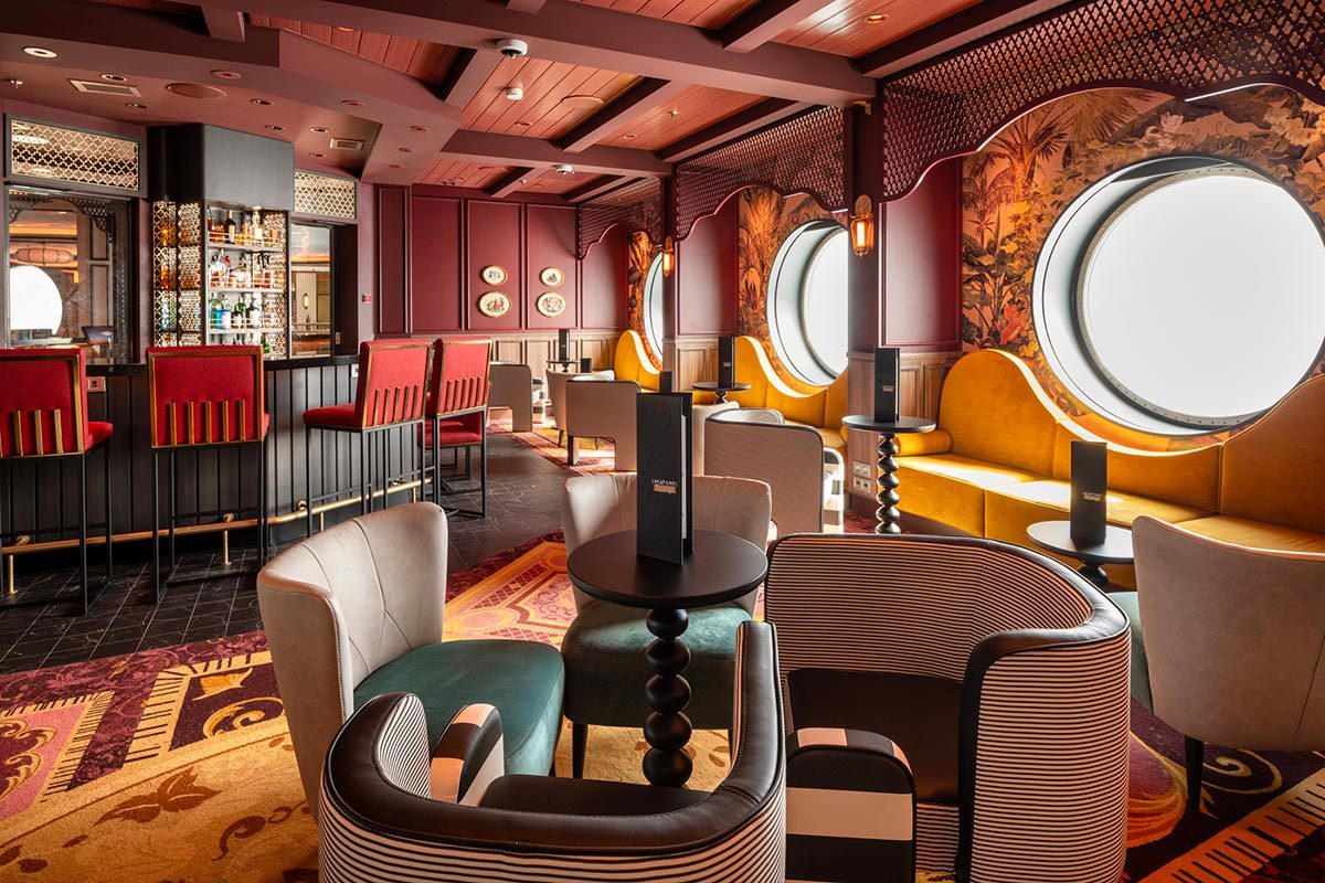 Warm colored bar/lounge with large portholes