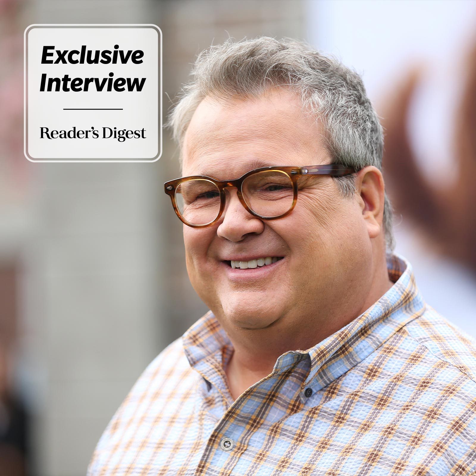 Headshot of Eric Stonestreet, wearing glasses and smiling, with "Exclusive Interview / Reader's Digest" in a box on the top left