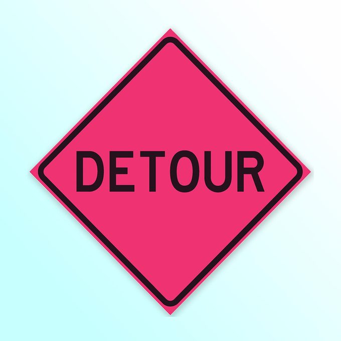 Pink traffic diamond that says "Detour" on a light blue background