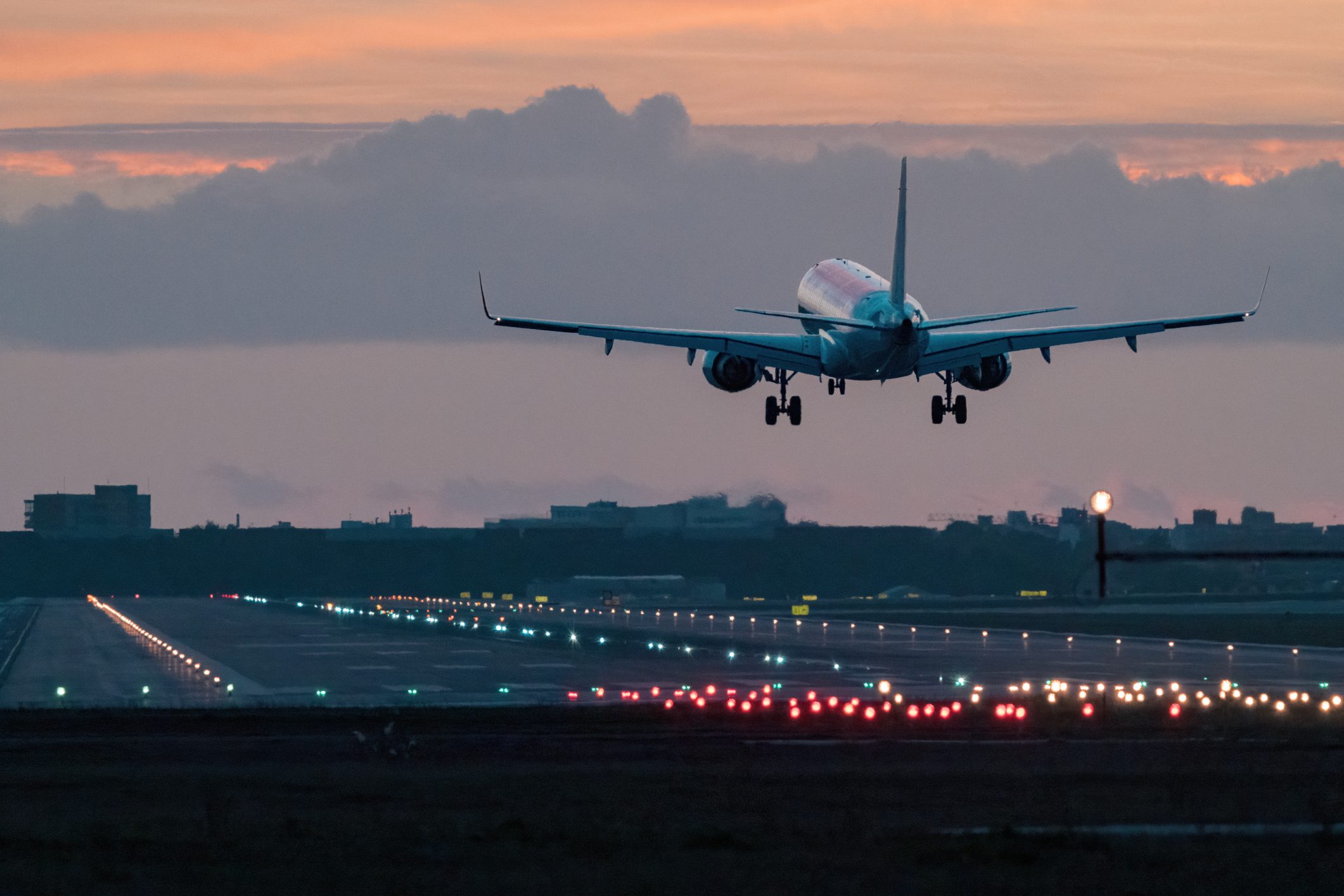 Airplane landing at sunrise