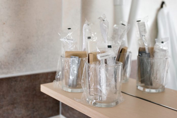 Close up view on the bottles with cosmetics and hygienic kit ain the hotel bathroom