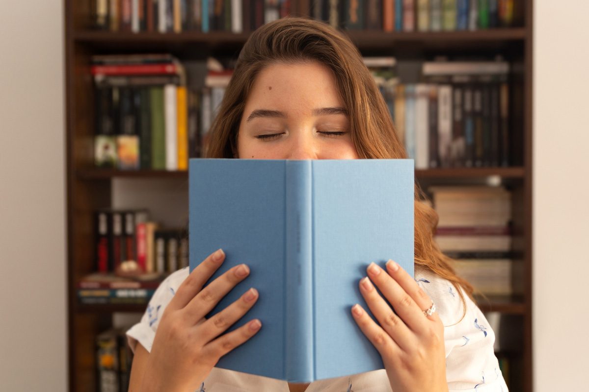 woman smelling book